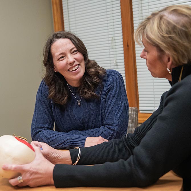a woman smiles to a dental staff at Guilford Hills Dental Care in Chambersburg, PA
