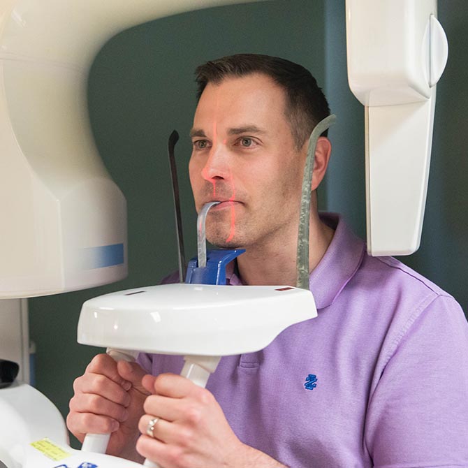 A man getting a dental exam at Guilford Hills Dental Care