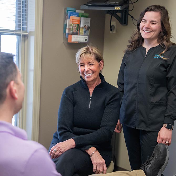 Dr. Laurie Sargent smiles with staff at a patient at Guilford Hills Dental Care in Chambersburg, PA