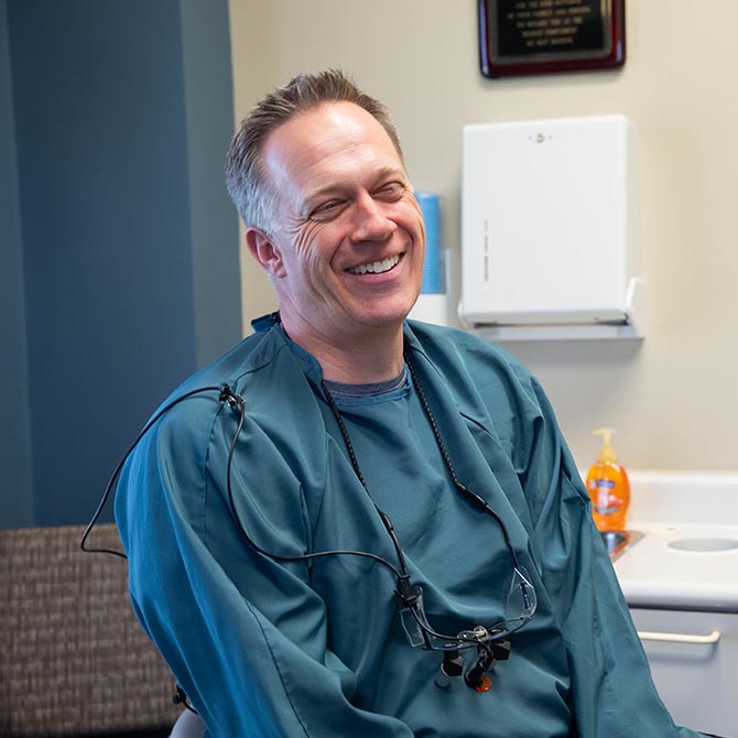 Dr. Adam Fulton in his scrubs inside the clinic of Guilford Hills Dental Care in Chambersburg, PA