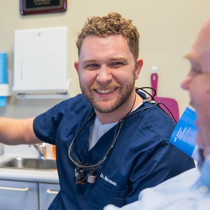 Dr. Jordan Newman smiles to a patient inside the clinic of Guilford Hills Dental Care in Chambersburg, PA